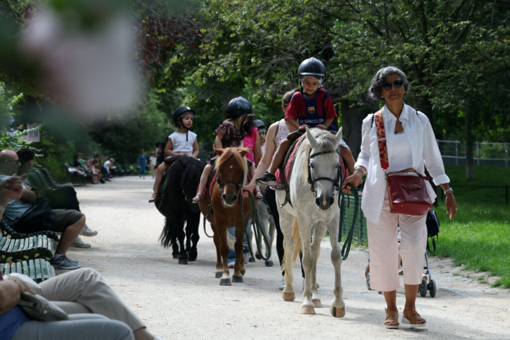 Children take a pony ride on the Parc Monceau as the city of Paris is introducing a ban on pony-riding starting from 2025 after the animal protection association, Paris Animaux Zoopolis warned of shortcomings in animal welfare in Paris, France, on 16th August, 2023