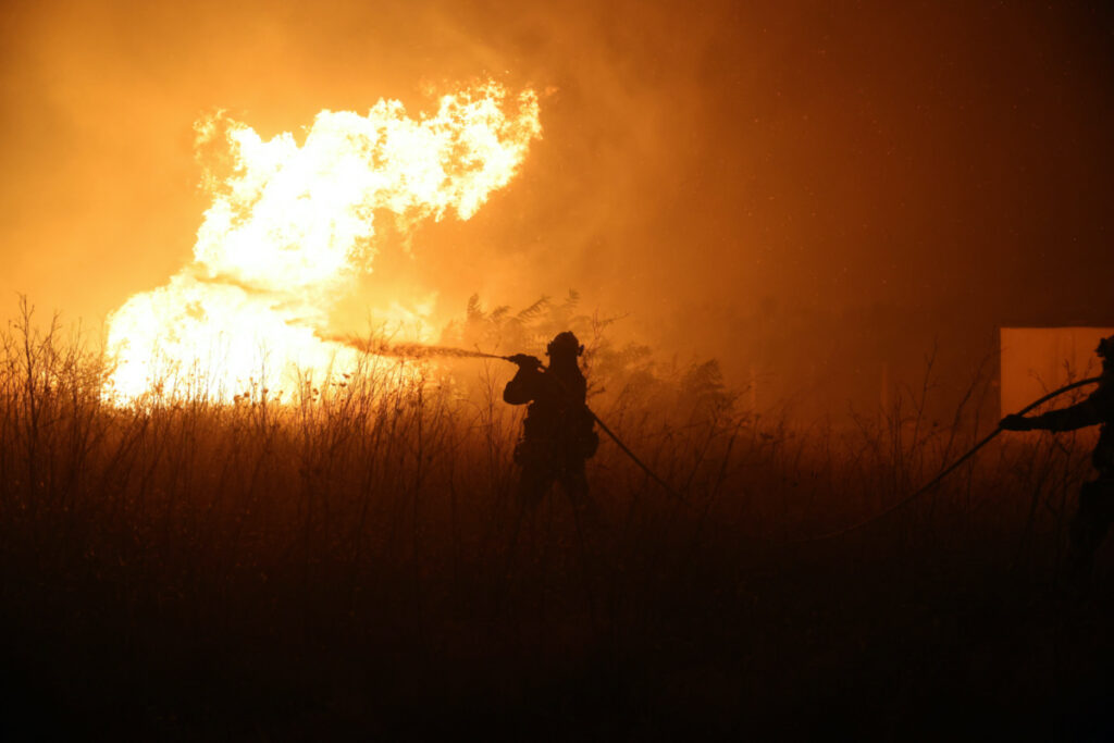 A firefighter tries to extinguish a wildfire burning near the village of Makri on the region of Evros, Greece, on 22nd August, 2023.