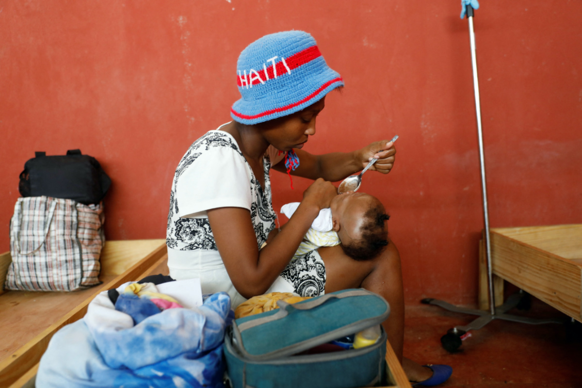 Monbeuil Kerline feeds her 8-month-old daughter, who is being treated at the Centre Hospitalier de Fontaine, located in the impoverished neighbourhood of Cite Soleil, where the two rival gangs, G-Pep and G-9, are based, in Port-au-Prince, Haiti, on 27th July, 2023