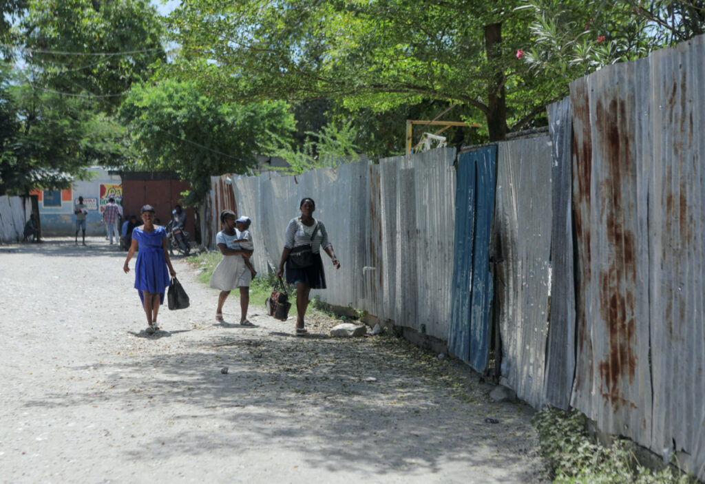 People walk past the installations of the humanitarian aid organisation El Roi Haiti after US nurse Alix Dorsainvil and her child were safely released following their kidnapping in Haiti two weeks ago, in Cite Soleil, in Port-au-Prince, Haiti, on 9th August, 2023.