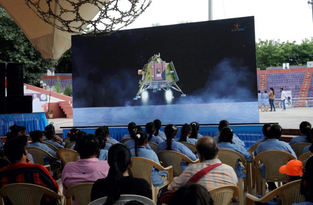 People watch a live stream of Chandrayaan-3 spacecraft's landing on the moon, inside an auditorium of Gujarat Science City in Ahmedabad, India, on 23rd August, 2023