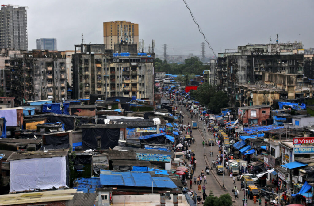People and vehicles move past shanties in Dharavi, one of Asia's largest slums, in Mumbai, India, on 1st August, 2023.