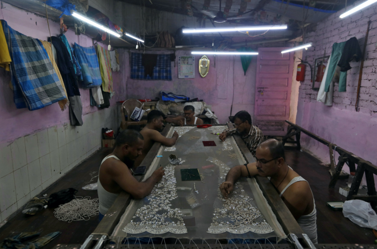 Artisans embroider a cloth inside a workshop in Dharavi, one of Asia's largest slums, in Mumbai, India, on 1st August, 2023