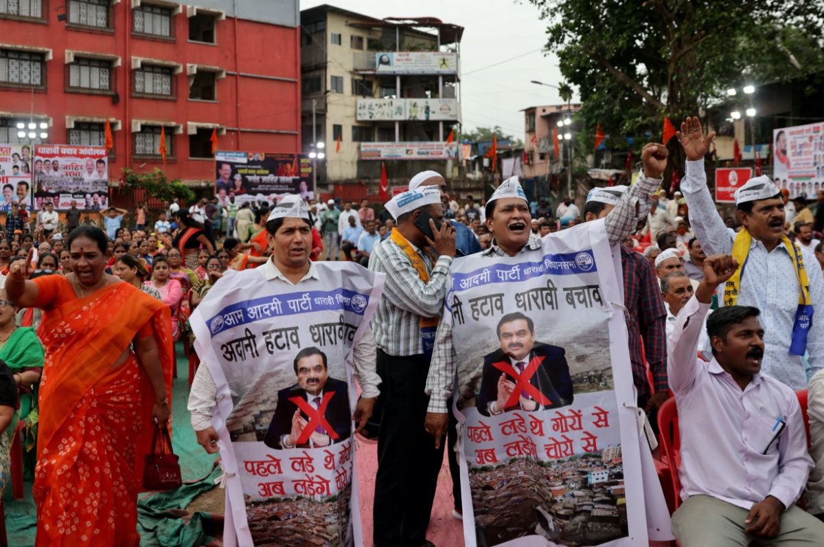 People shout slogans as they wear banners during a protest against the redevelopment of Dharavi, one of Asia's largest slums, by the Adani Group in Mumbai, India, on 9th August, 2023.