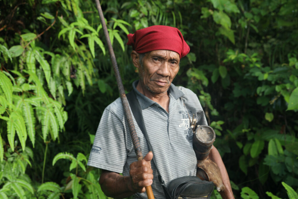 Mino Nente, an elder of the Indigenous Wana people, holding a wooden blowpipe in North Morowali Regency on the Indonesian island of Sulawesi on 12th March, 2023