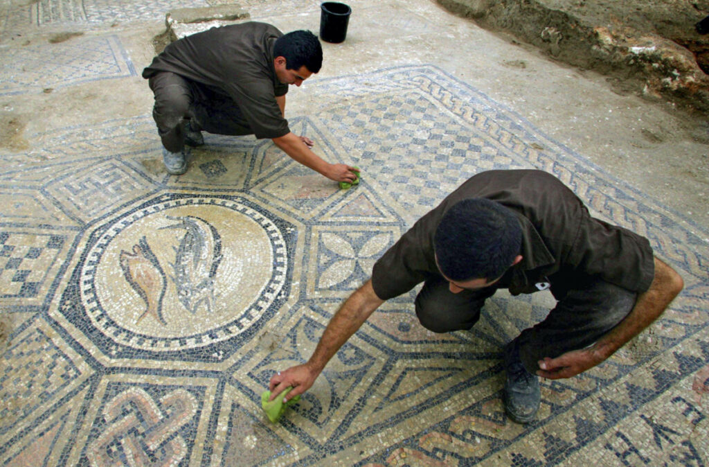 Prisoners work at a nearly 1,800-year-old decorated floor from an early Christian prayer hall discovered by Israeli archaeologists on Sunday, 6th November, 2005 in the Megiddo prison.