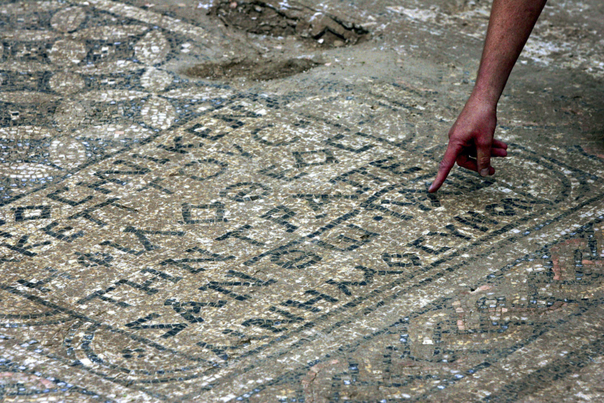 An Israeli archaeologist points at a nearly 1,800-year-old decorated floor from an early Christian prayer hall that Israeli archaeologists discovered on Sunday, 6th November, 2005, in the Megiddo prison.