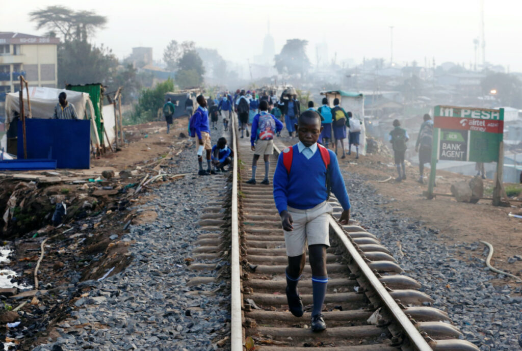 A schoolboy walks along the Kenya-Uganda railway line during the reopening of schools, after the government closed learning institutions due to the coronavirus disease outbreak, in Kibera slums of Nairobi, Kenya, on 4th January, 2021.