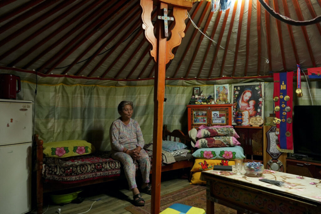 Catholic devotee Perlimaa Gavaadandov, 71, recites a Christian prayer before bed in a yurt on the outskirts of Arvaikheer city, Mongolia, on 28th August, 2023