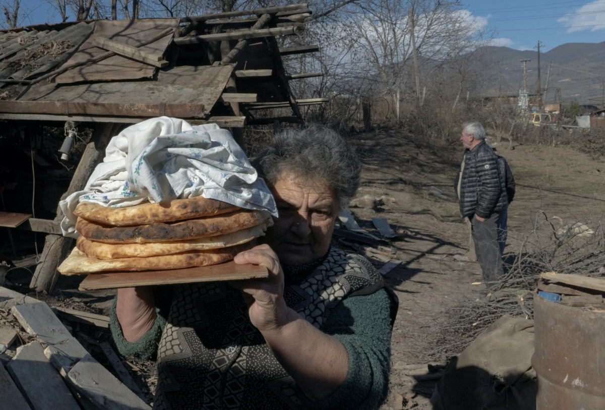 Local resident Zina Fatyan carries freshly baked bread in the village of Taghavard in the region of Nagorno-Karabakh, on 15th January, 2021.