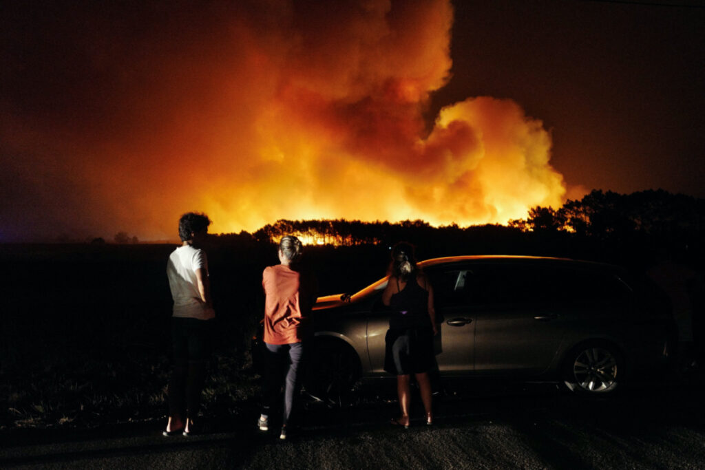 People watch a wildfire in Aljesur, Portugal, on 7th August, 2023.