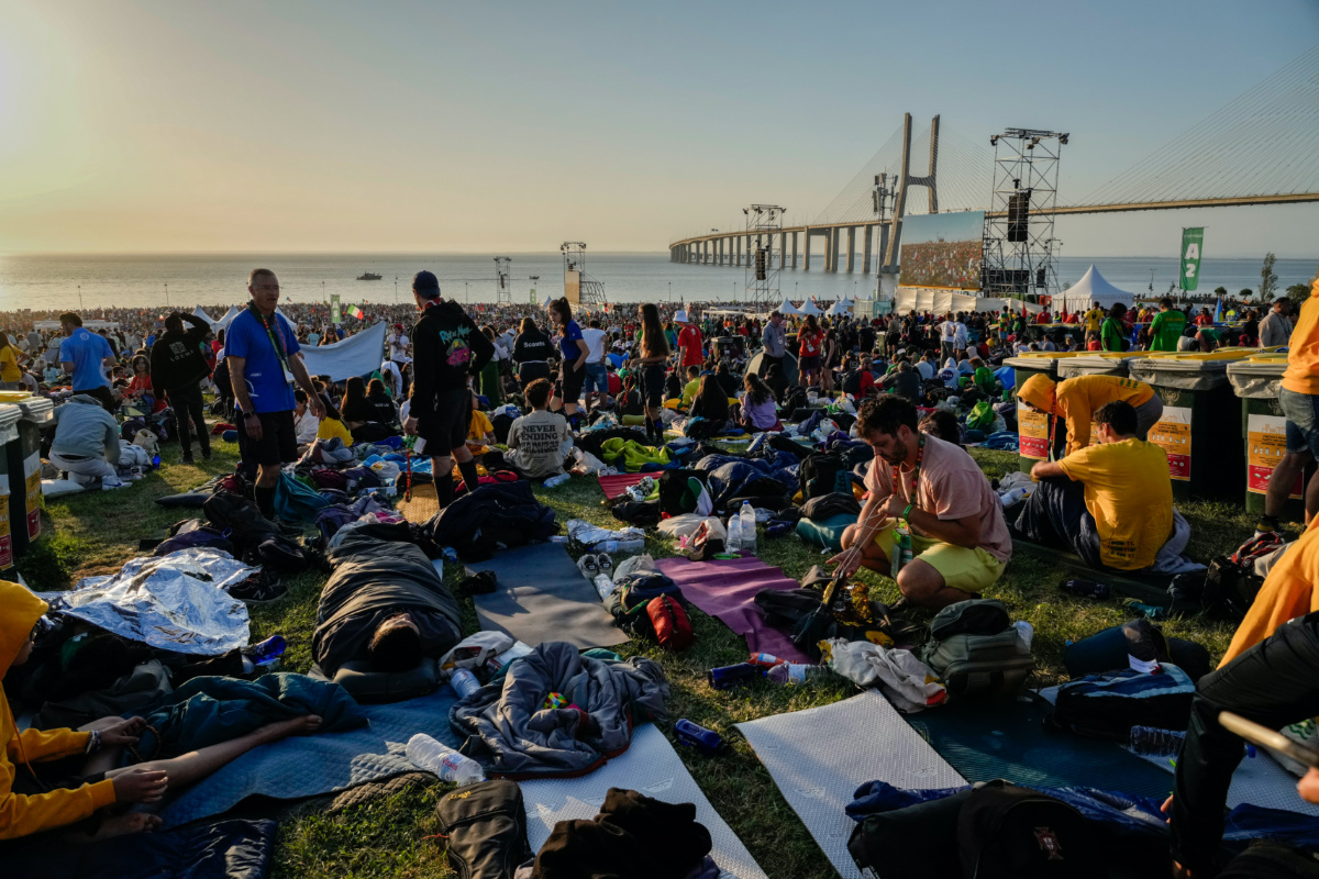 Pilgrims wake up after sleeping at the Parque Tejo in Lisbon where Pope Francis will preside over a mass celebrating the 37th World Youth Day, on Sunday, 6th August, 2023. 