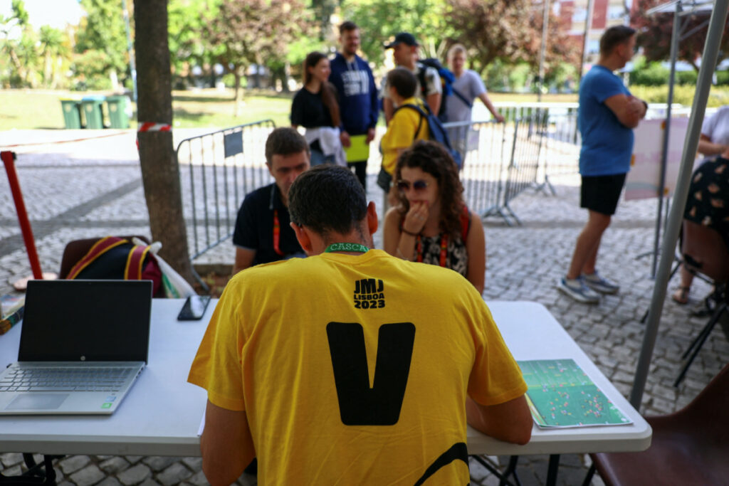 A volunteer does the registration check-in of pilgrims on the first day of the XXXVII World Youth Day, in Lisbon, Portugal, on 1st August, 2023.