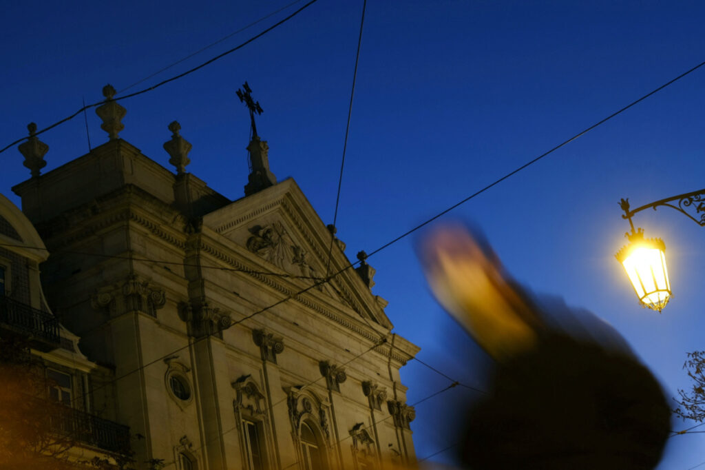 A person walks by a church in the center of Lisbon, Portugal, on 2nd December, 2021.