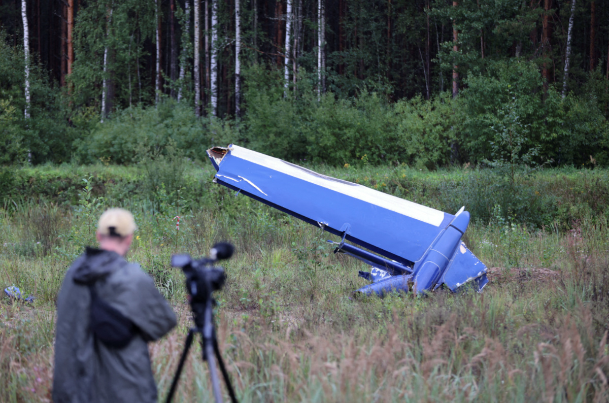A cameraman films a wreckage of the private jet linked to Wagner mercenary chief Yevgeny Prigozhin near the crash site in the Tver region, Russia, on 24th August, 2023