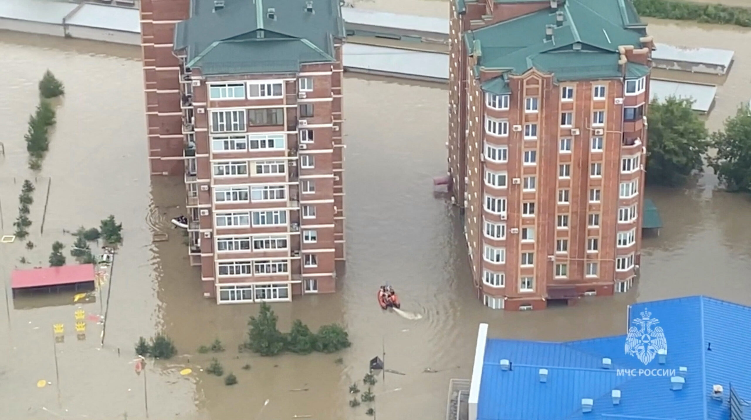 Rescuers use inflatable boats to evacuate residents of the area flooded due to a dam break in Ussuriysk, Russia, in this still image taken from video released on 12th August, 2023. 