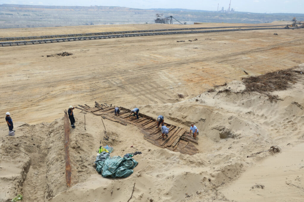 Archaeologists excavate the hull of a wooden ship, an ancient Roman flat-hulled riverine vessel at the ancient city of Viminacium, near Kostolac, Serbia, on 2nd August, 2023.