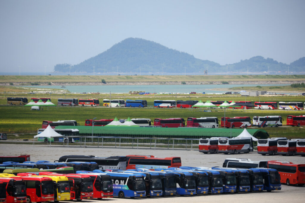 Buses wait in a long line to transport participants leaving the campsite of the 25th World Scout Jamboree in Buan, South Korea, on 8th August, 2023.