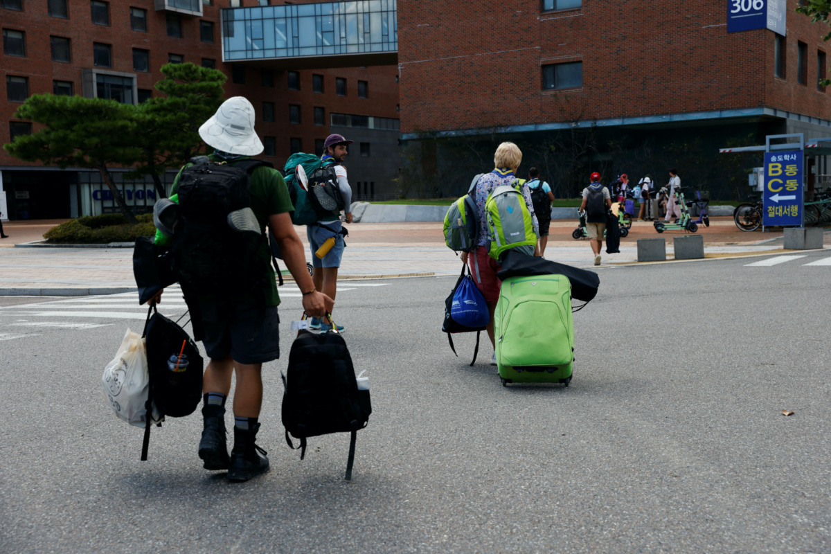 Participants who left the camping site of the 25th World Scout Jamboree, arrive at a university in Incheon, South Korea, on 8th August, 2023