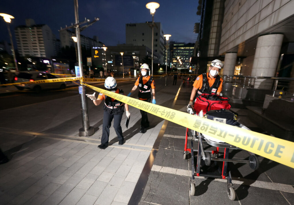 Rescue workers are seen at a scene where, according to media reports, nine people have been stabbed and four others hurt by a car driven by the suspected attacker in Seongnam, South Korea, on 3rd August, 2023.