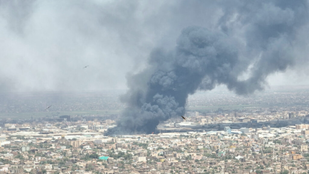 Drone footage shows birds in the foreground as clouds of black smoke billow over Bahri, also known as Khartoum North, Sudan, in this 1st May, 2023 video