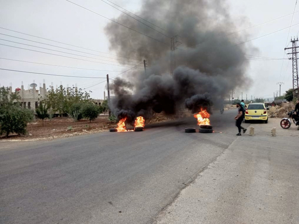 Tires burn as demonstrators protest against the Syrian government decision on increasing the prices of fuels in Sweida, Syria, on 17th August, 2023.