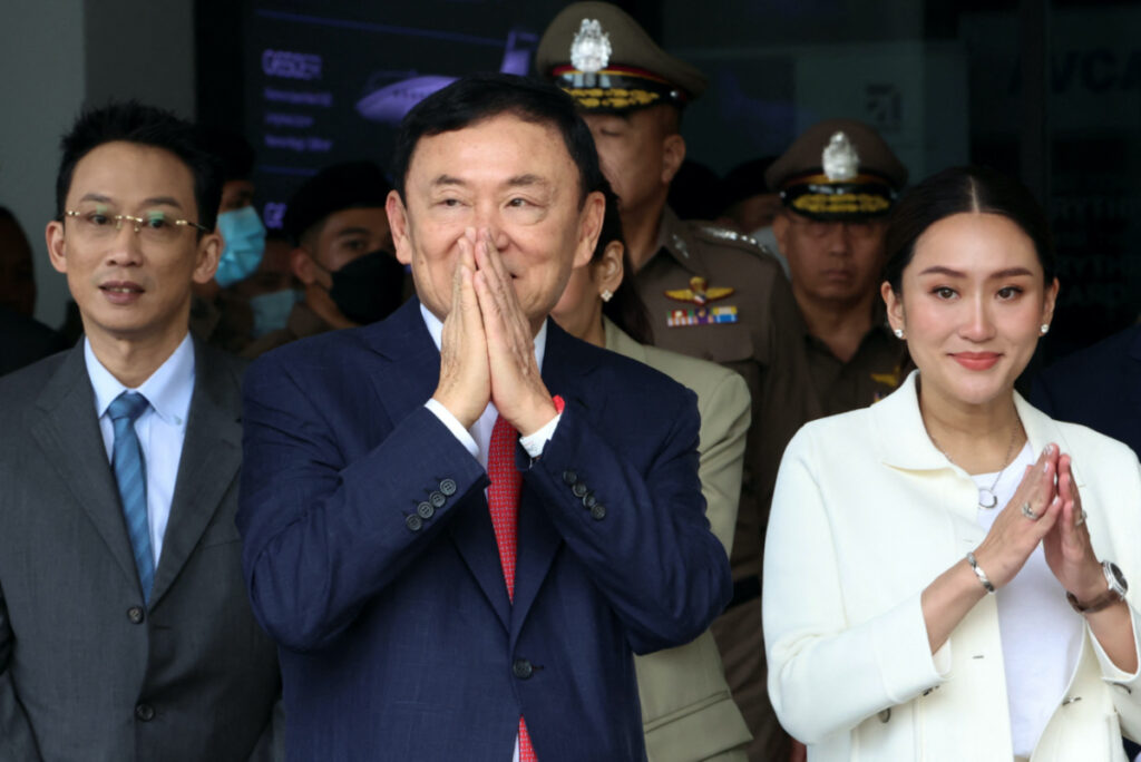 Former Thai Prime Minister Thaksin Shinawatra, who is expected to be arrested upon his return as he ends almost two decades of self-imposed exile, gestures while flanked by his son Panthongtae Shinawatra and daughter Paetongtarn Shinawatra at Don Mueang airport in Bangkok, Thailand, on 22nd August, 2023.