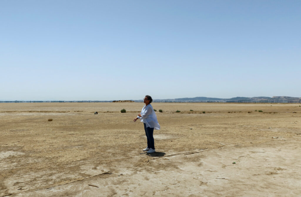 Tunisian environmental activist, Radhia Haddad, stands on the dried-out Ariana lagoon, in Ariana, Tunisia, on 11th August, 2023