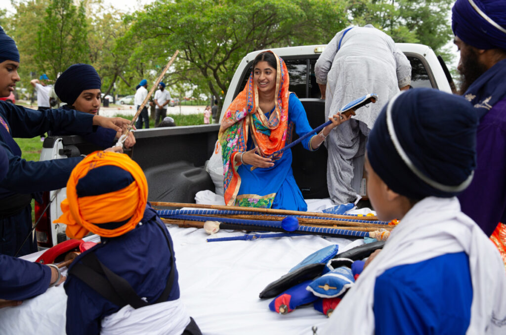 Jasmeen Kaur and other members of the Sikh Religious Society of Palatine prepare to participate in the Parade of Faiths in downtown Chicago on 13th August, 2023.