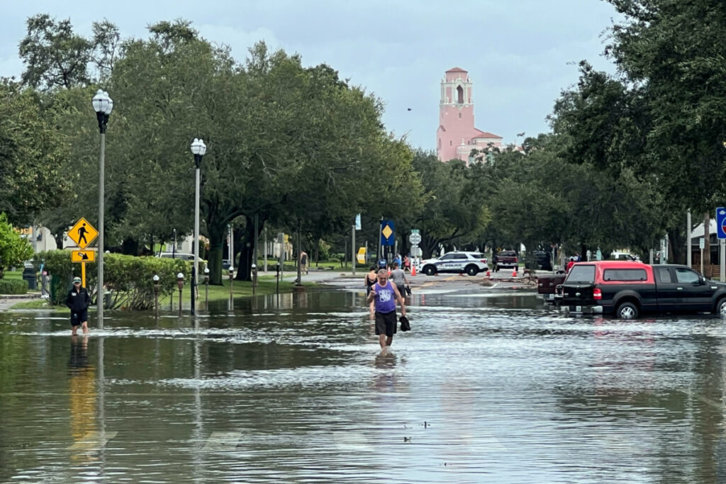 People wade through flood waters after Hurricane Idalia passed to the north, in St. Petersburg, Florida, US, on 30th August, 2023