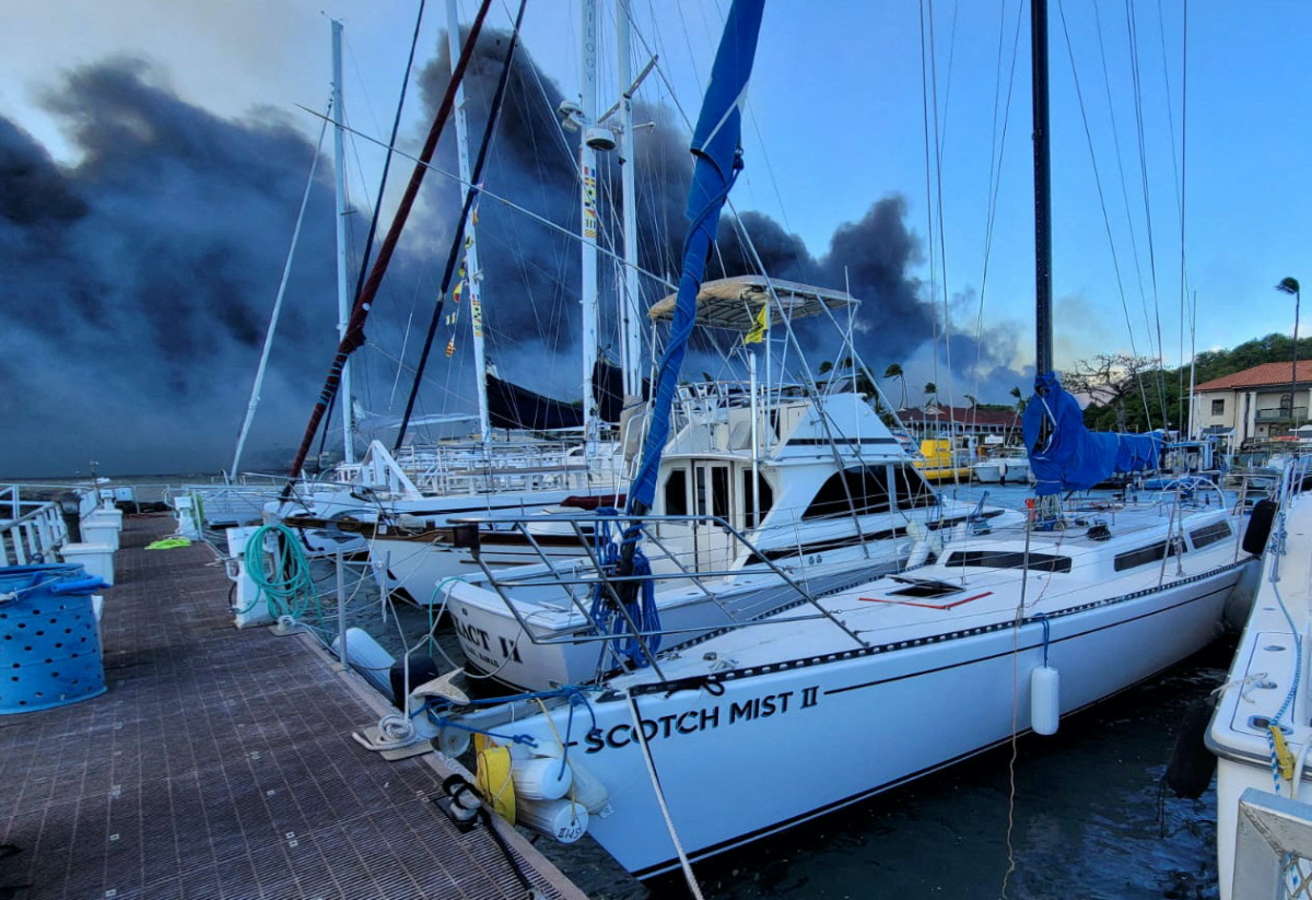 Smoke billows near boats docked at Lahaina as wildfires driven by high winds destroy a large part of the historic town of Lahaina, Hawaii, US, on 9th August 9, 2023