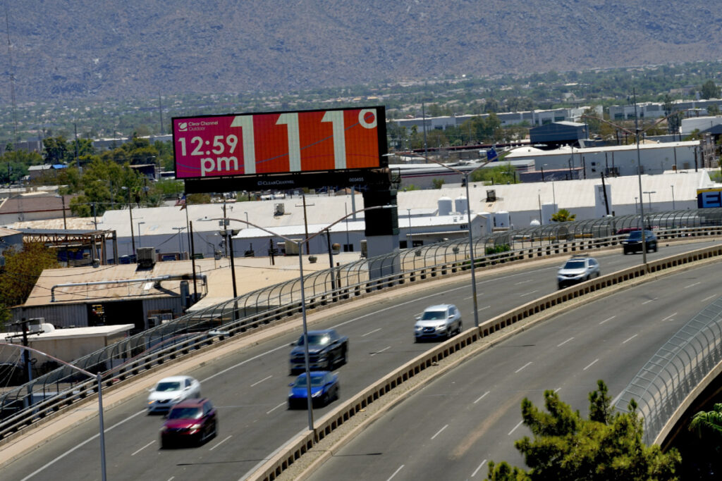 A digital billboard displays an unofficial temperature, on 17th July, 2023, in downtown Phoenix.