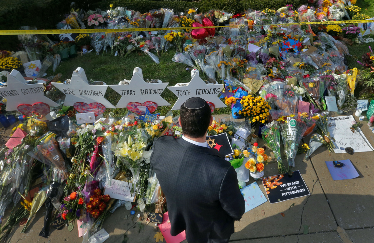 A man prays at a makeshift memorial outside the Tree of Life synagogue in Pittsburgh, Pennsylvania, on 31st October, 2018. 
