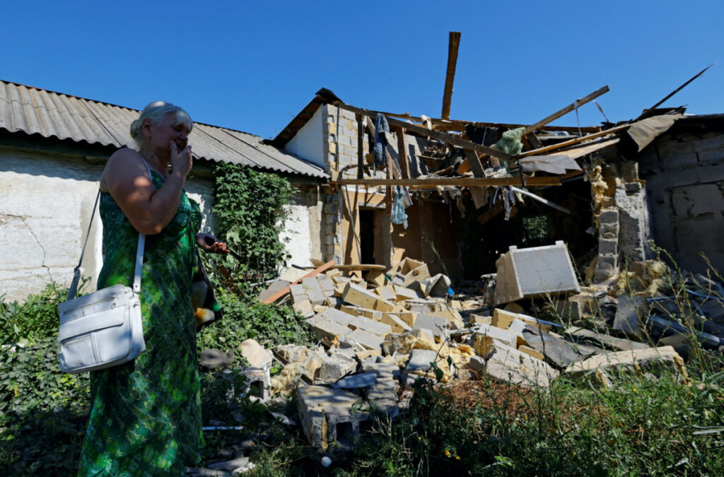 Lyubov Tolchina, 63, reacts next to the damaged house of her son Vitaly, 40, who was killed the day before by shelling in the course of Russia-Ukraine conflict in Donetsk, Russian-controlled Ukraine, on 13th August, 2023.