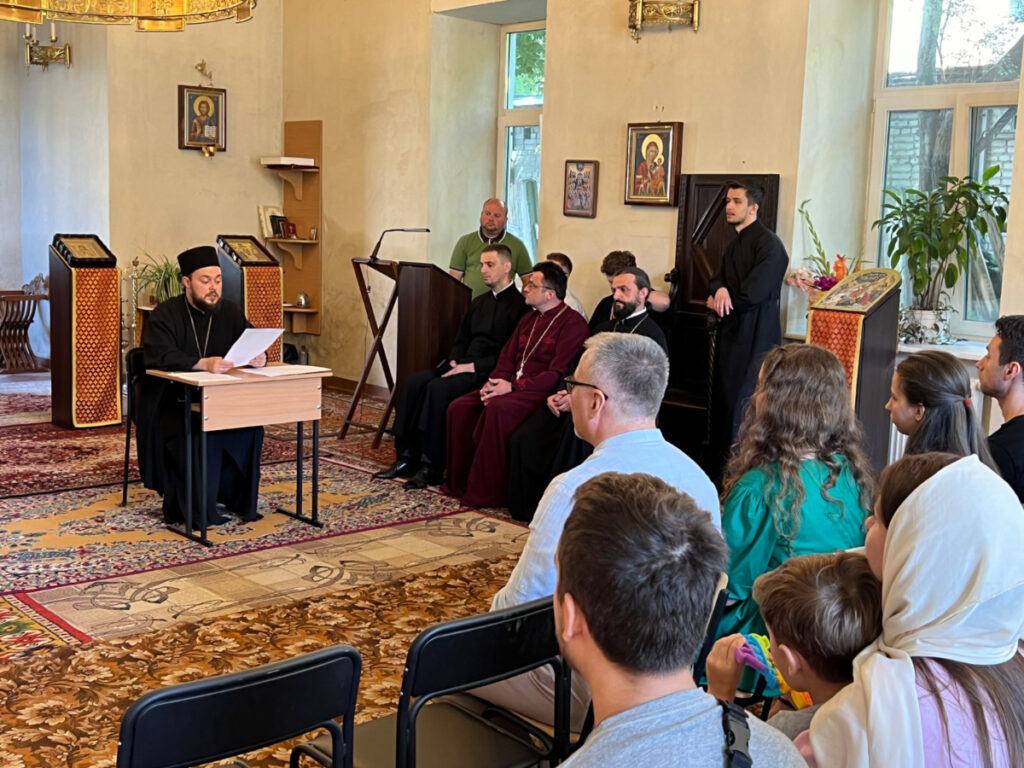 Abbot Job Olshansky, left, speaks at a parish meeting of the Holy Resurrection New Athos Monastery in Lviv, Ukraine, on 13th August, 2023.