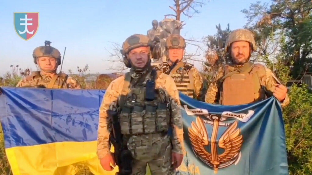 Ukrainian soldiers stand with Ukrainian flag in Urozhaine, Donetsk Region, Ukraine in this screen grab obtained from a handout video released on 16th August, 2023.