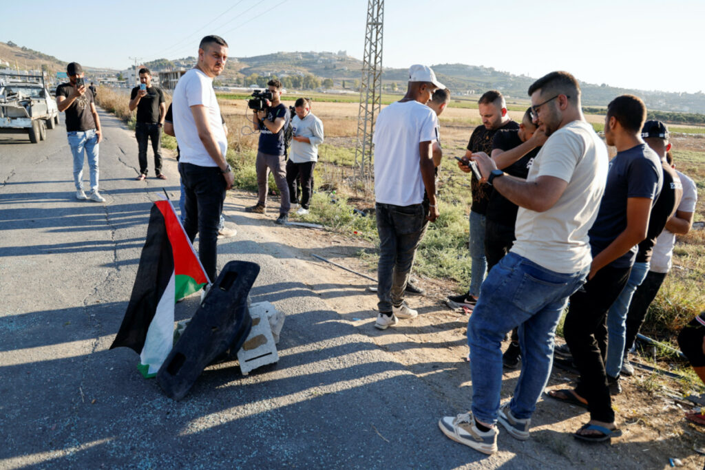 Palestinians gather at the scene where Israeli forces targeted a Palestinian car, near Jenin, in the Israeli-occupied West Bank, on 6th August, 2023.