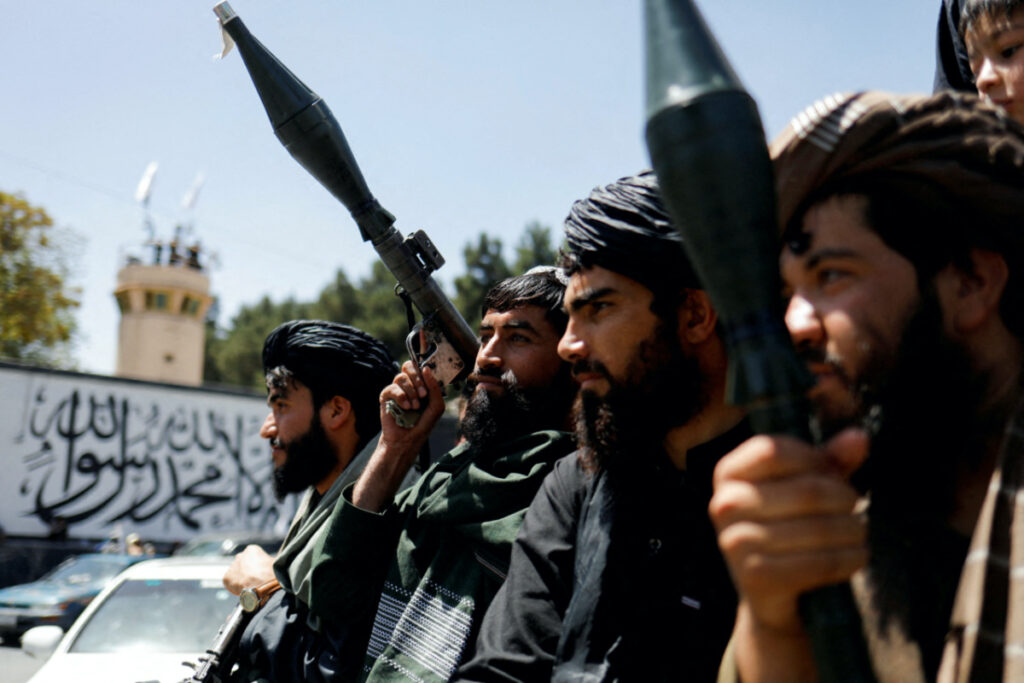 Taliban soldiers celebrate on the second anniversary of the fall of Kabul on a street near the US embassy in Kabul, Afghanistan, on 15th August, 2023