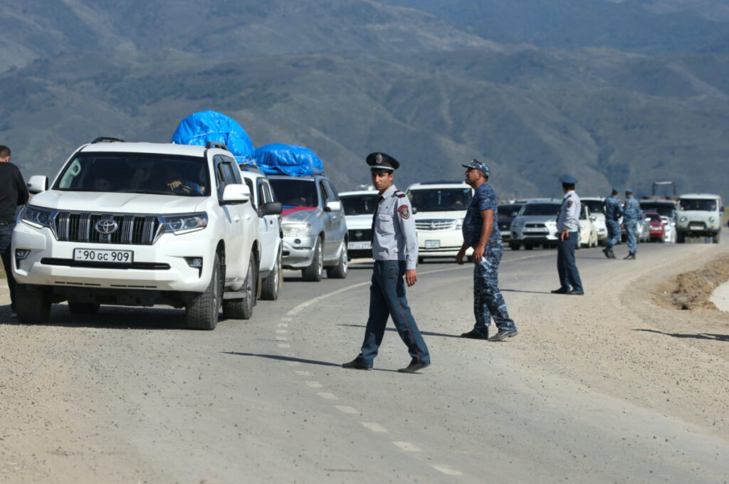 Armenian law enforcement officers stand guard at a checkpoint as refugees flee Nagorno-Karabakh region and arrive in the border village of Kornidzor, Armenia, on 27th September, 2023