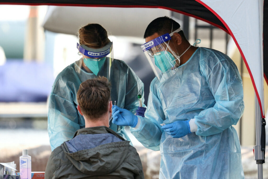 Medical personnel administer tests for the coronavirus disease at a pop-up testing centre, as the state of New South Wales grapples with an outbreak of new cases, in Sydney, Australia, on 30th July, 2020.