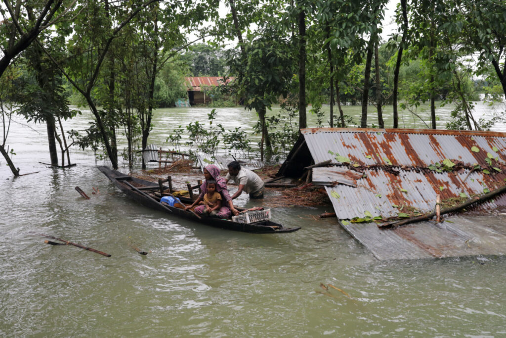 People get on a boat as they look for shelter during a widespread flood in the northeastern part of the country, in Sylhet, Bangladesh, 19th June, 2022