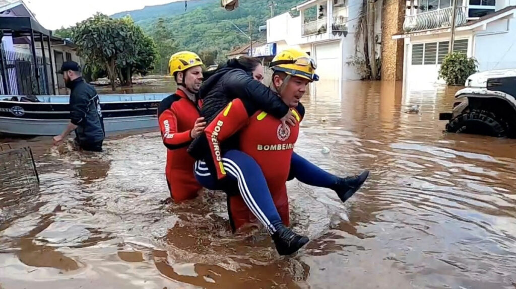 Rescuers carry a person after an extratropical cyclone hit southern cities, in Mucum, Rio Grande do Sul state, Brazil in this screen grab taken from a video released on 6th September, 2023.