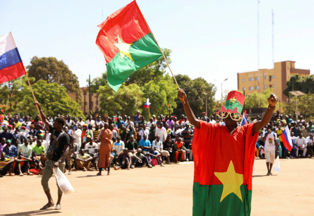 A man holds his national flag as people gather to show their support to the Junta leader Ibrahim Traore and demand the departure of the French ambassador at the Place de la Nation in Ouagadougou, Burkina Faso, on 20th January, 2023.