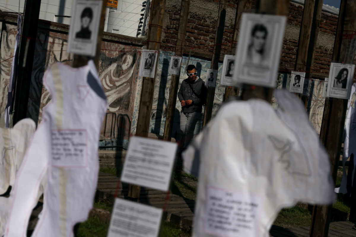 A man walks among signs in memory of detained and missing people at Jose Domingo Canas memorial house, a former detention, torture and forced disappearance quarters of the secret police of the Augusto Pinochet dictatorship, ahead of the 50th anniversary of the coup d'etat, in Santiago, Chile, on 30th August, 2023.