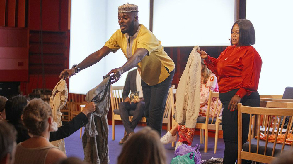 Sammy Oteng and Abena Essoun pass secondhand clothing from Accra’s beaches to the audience at the Global Fashion Summit in Copenhagen on 27th June 2023