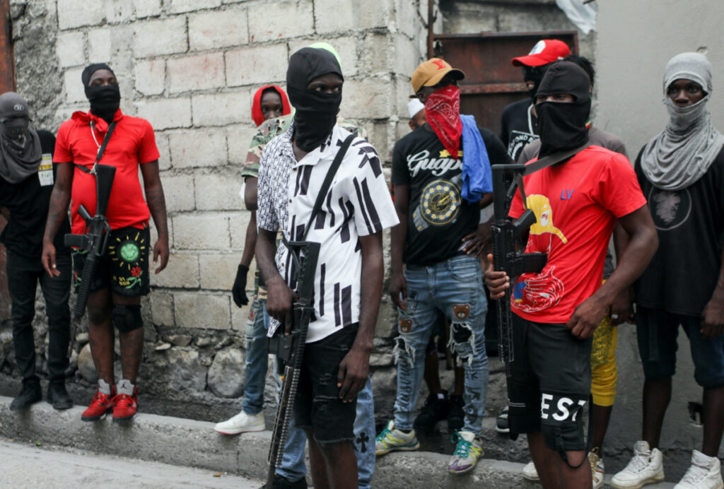 Former police officer Jimmy "Barbecue" Cherizier - not pictured - leader of the 'G9' coalition, is accompanied by Security during a march against Haiti's Prime Minister Ariel Henry, in Port-au-Prince, Haiti, on 19th September, 2023.