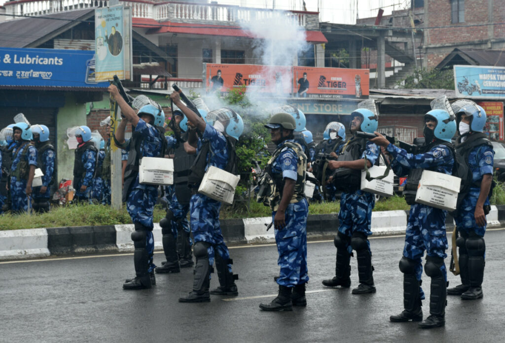 Riot police officers fire tear smoke shells to disperse demonstrators protesting against the arrest of five people, who police said were carrying weapons while wearing camouflage uniform, in Imphal, Manipur, India, on 18th September, 2023