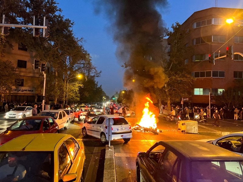 A police motorcycle burns during a protest over the death of Mahsa Amini, a woman who died after being arrested by the Islamic republic's "morality police", in Tehran, Iran on 19th September, 2022