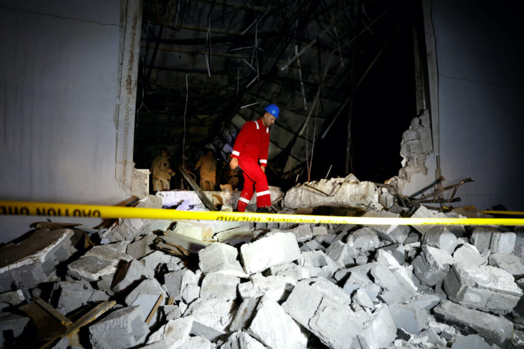 An emergency worker walks over rubble at the site following a fatal fire at a wedding celebration, in the district of Hamdaniya in Iraq's Nineveh province, Iraq, on 27th September, 2023