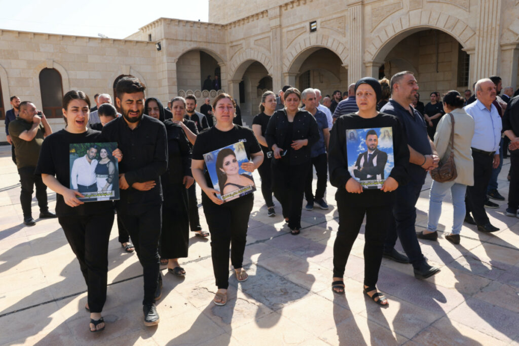 Iraqi Christians react as they leave after attending a mass following a fatal fire at a wedding celebration, at the Grand Immaculate Church, in Hamdaniya, Iraq, on 28th September, 2023